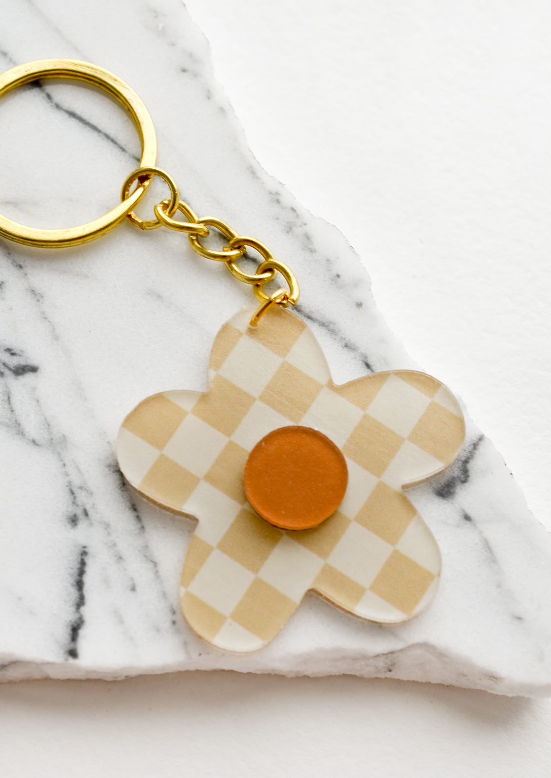 Flower shaped keychain in beige checker print.