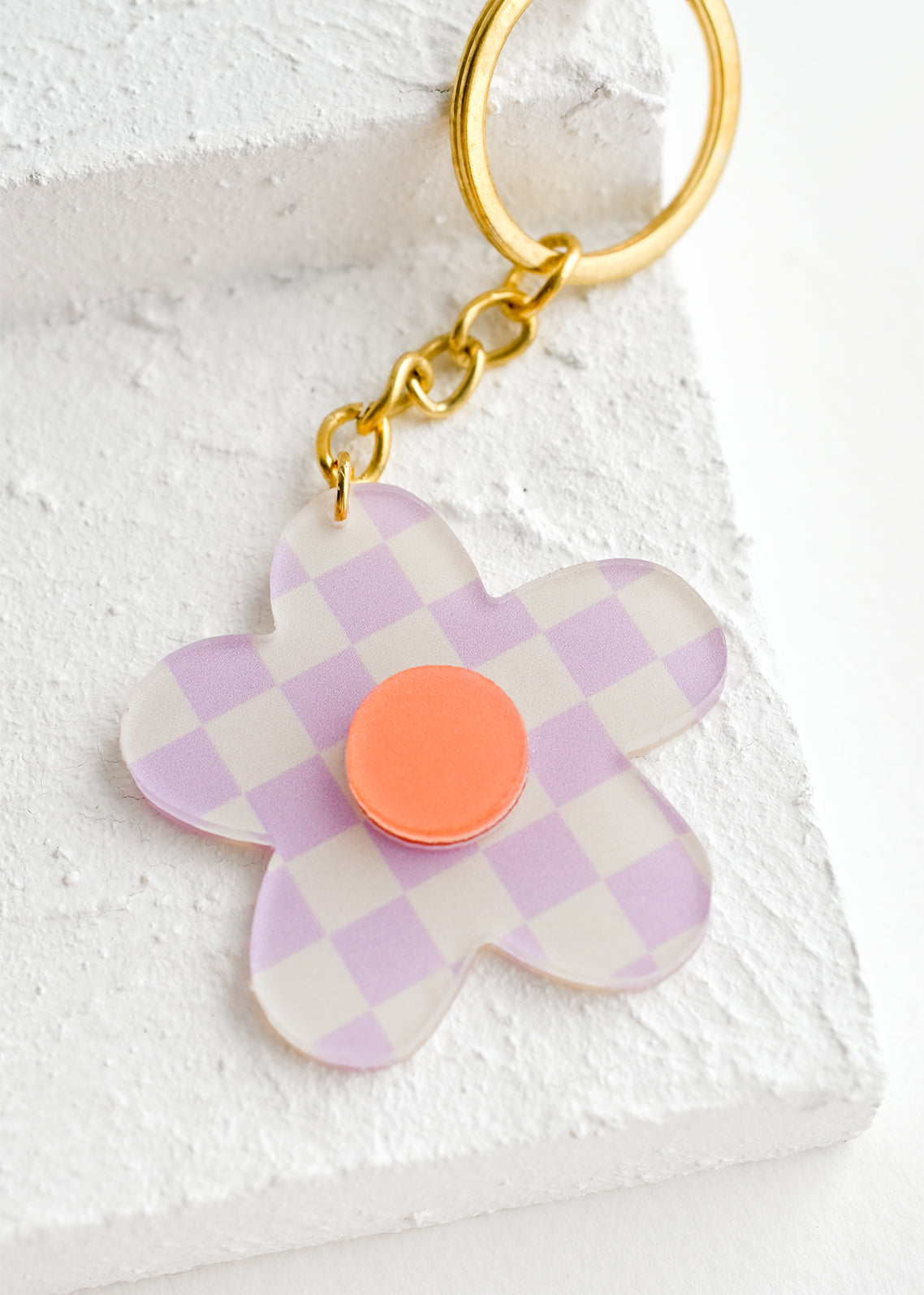 Flower shaped keychain in purple checker print.